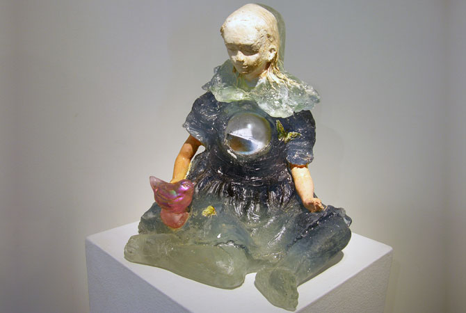 A glass sculpture of a young child.