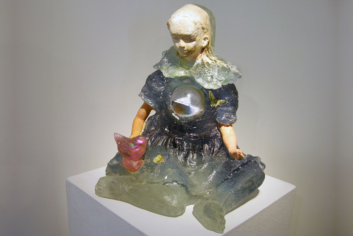 A glass sculpture of a young child.