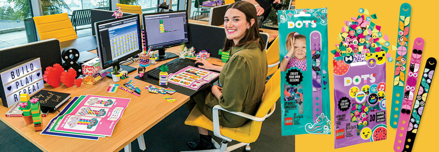 Amy Corbett smiles while sitting at her work desk.