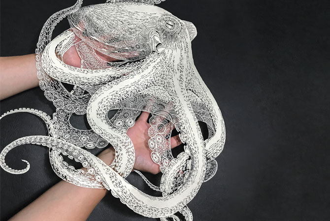 Masayo Fukuda holds an octopus made of paper.