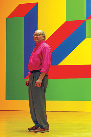 Man standing in front of a colorful art piece