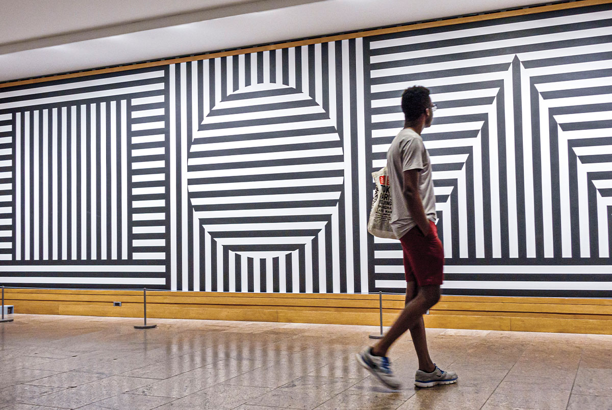 Person observing black & white geometric line art pieces