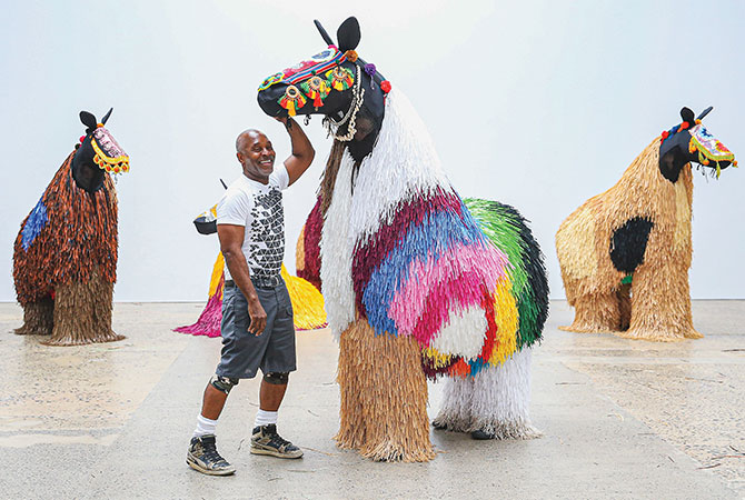 Enlargeable photo of artist with the creatures he created