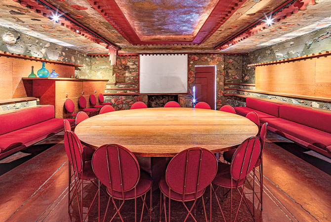Enlargeable photo of metal and wooden furniture in a room with stone walls