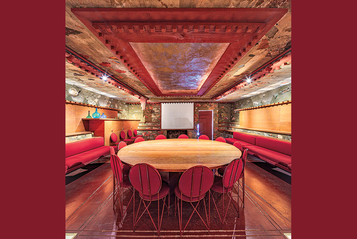 Metal and wooden furniture in a room with stone walls