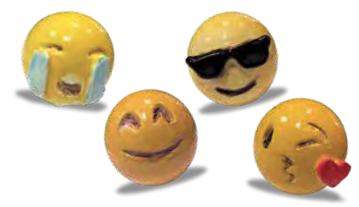 Small figurines of emojis: A crying emoji, emoji with sunglasses, kissy emoji and smiley emoji