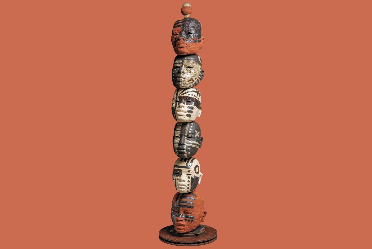 Image of small heads stacked on top of each other to form a tower