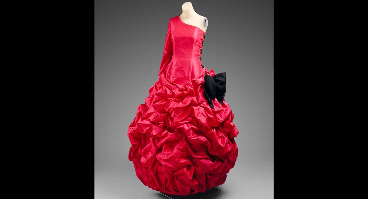 Image of a red dress with a very full bottom worn by a mannequin