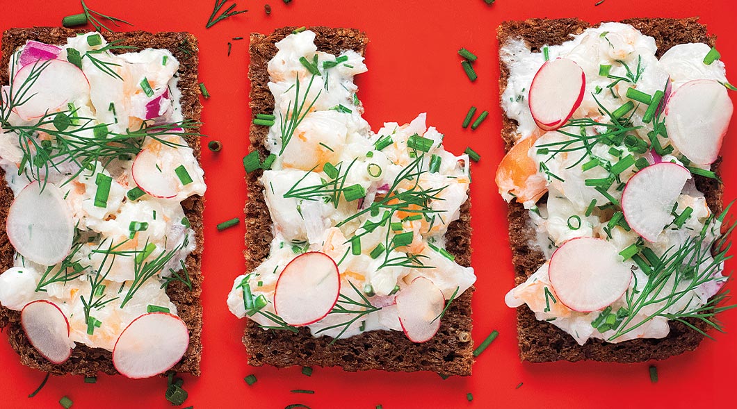 Image of three pieces of toast with salmon and radishes on it