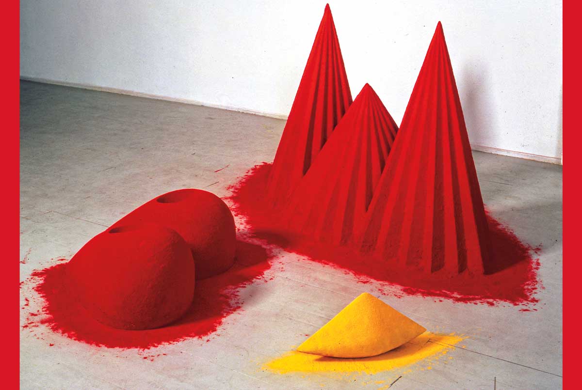 Image of three different structures made from powder, two are red and one is yellow
