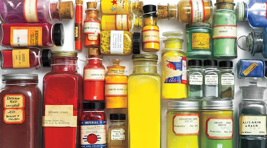 Image of a variety of different colored powders in glass bottles