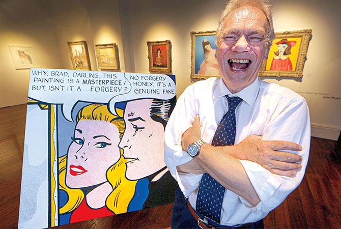 Enlargeable photo of man laughing next to cartoon art piece