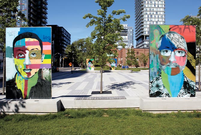 Enlargeable image of two colorful murals in a city park